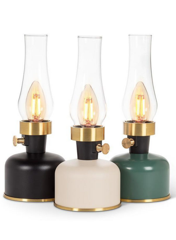 Three LED lantern-style lamps with chimneys. From left to right, they are black, ivory, and green.