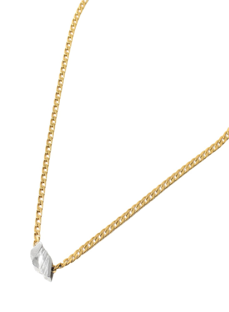 The Anne Maria Chagnon Athenes Necklace features a medium weight gold cuban link style chain with an organically textured drop of pewter as the pendant